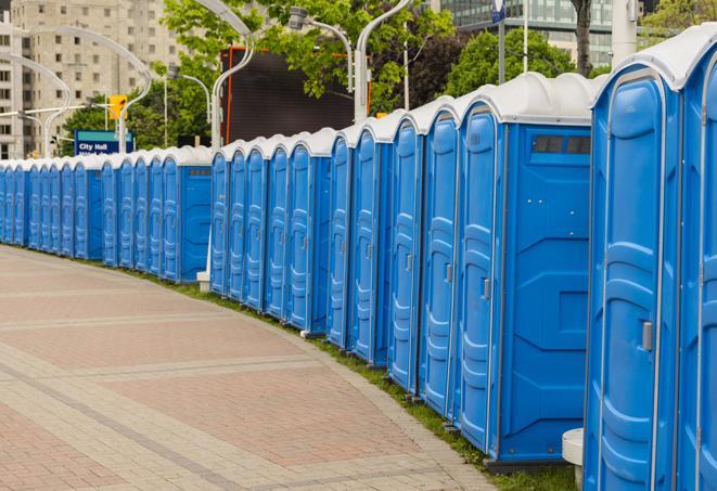 portable restrooms stationed outside of a high-profile event, with attendants available for assistance in Anaheim